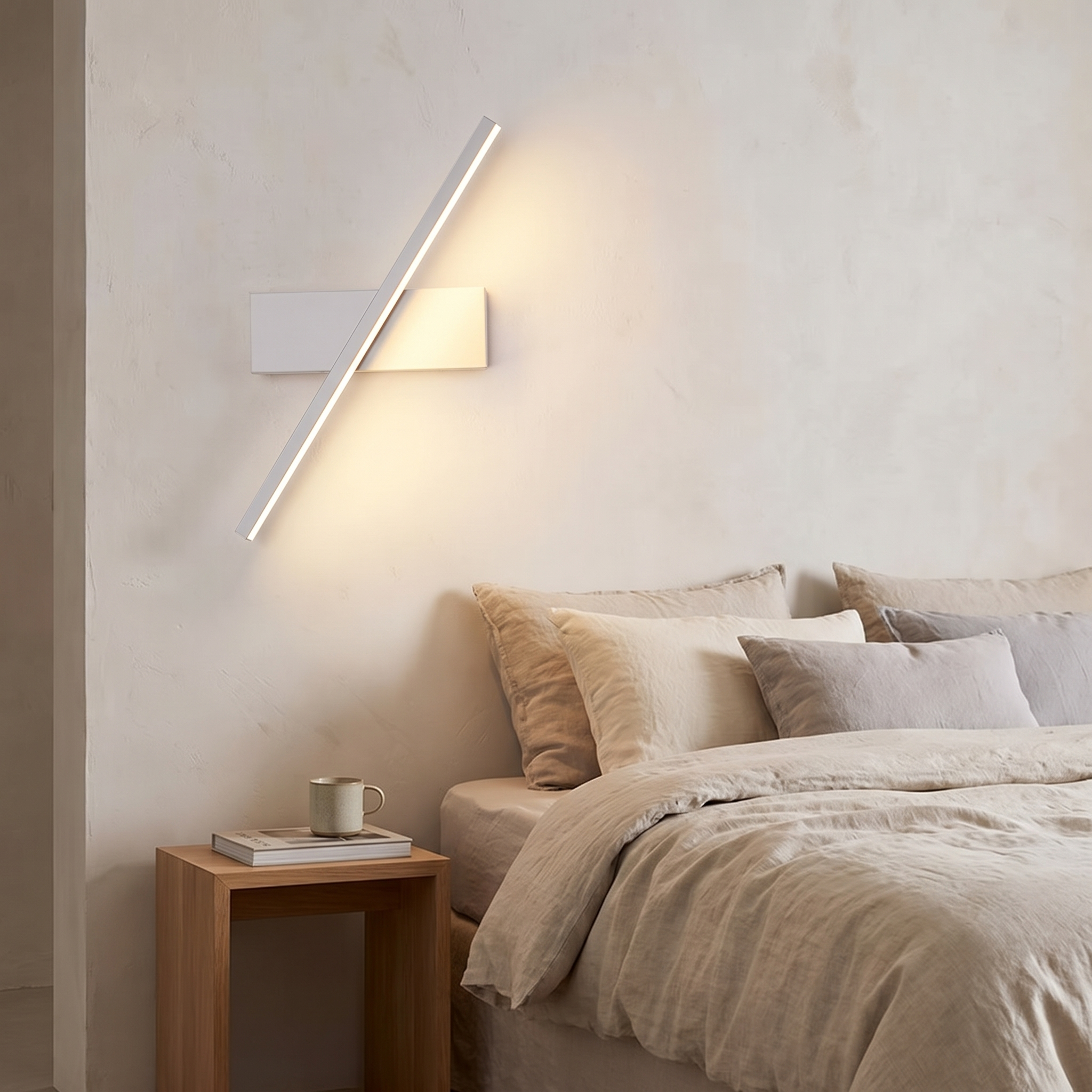 Modern wall sconce mounted beside a bed in a calm bedroom