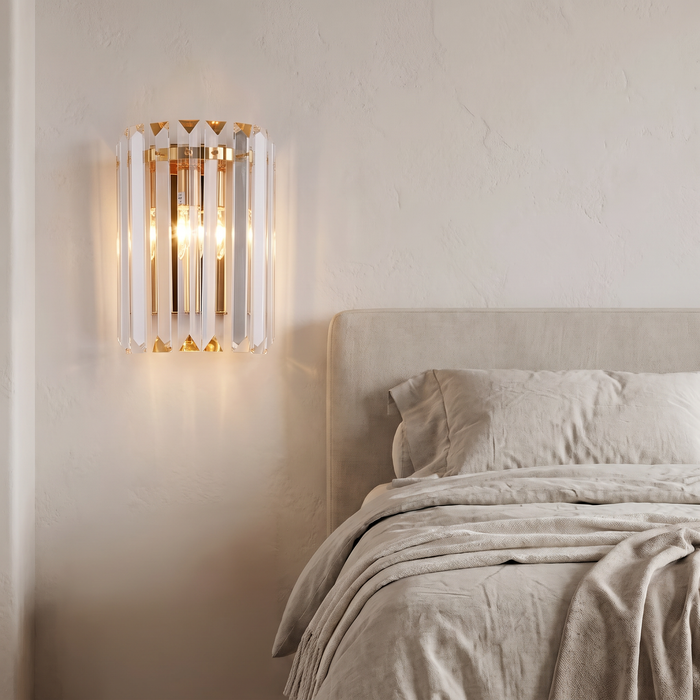Crystal wall light beside a bed in a modern bedroom