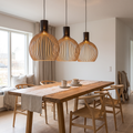 Handcrafted wooden pendant light above a timber dining table