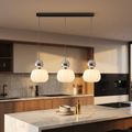 Nordic pumpkin pendant light above a kitchen island