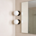 Nordic globe glass wall lamp beside a bathroom mirror