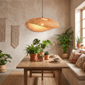 Handwoven bohemian rattan pendant lampshade above a dining table