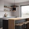 Minimalist pendant light above a kitchen breakfast bar