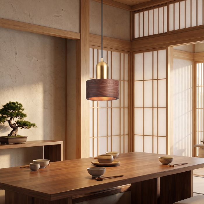 Walnut and brass cylinder pendant lamp above a dining table