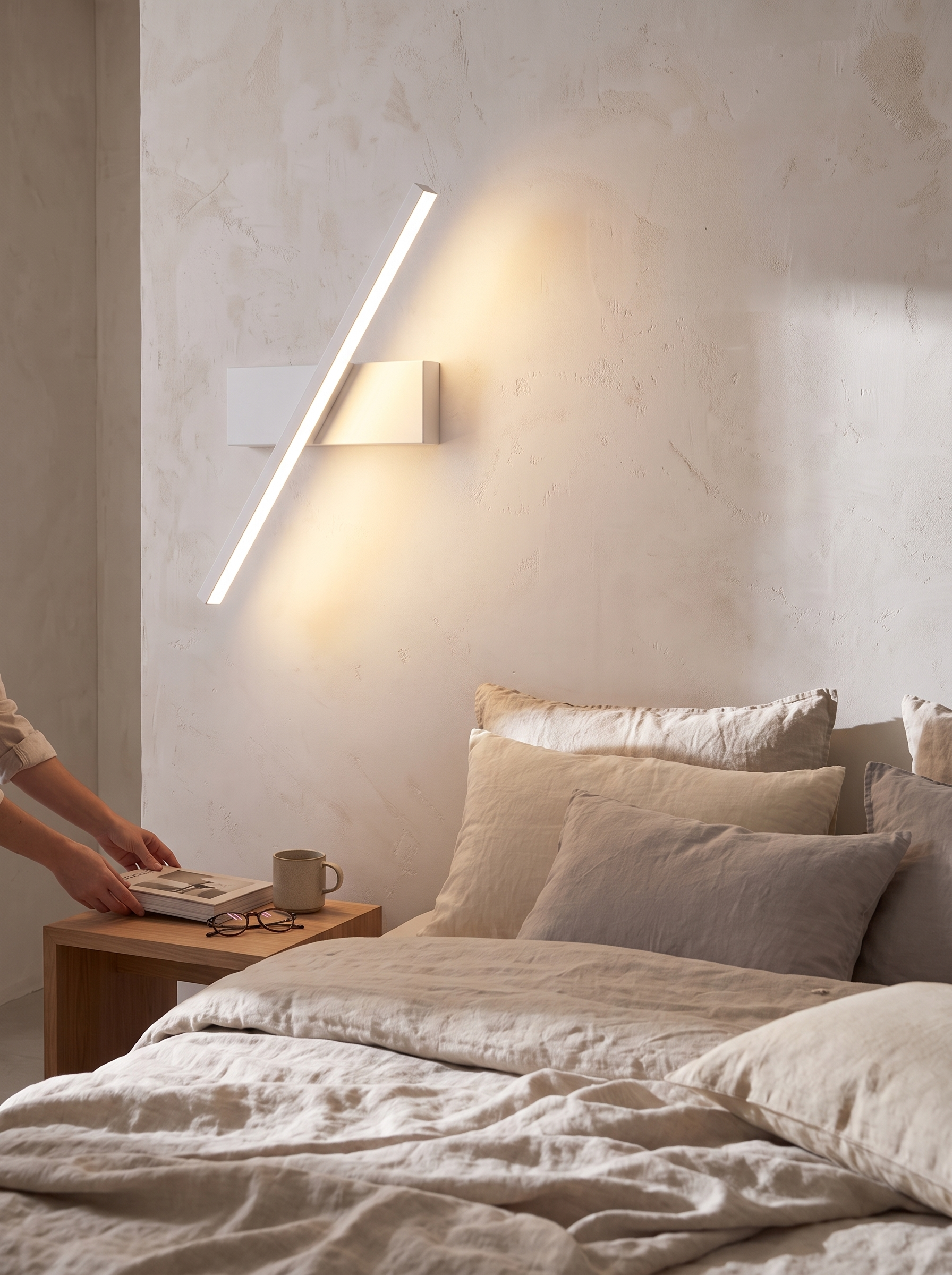 Rotatable LED wall sconce mounted along a hallway wall